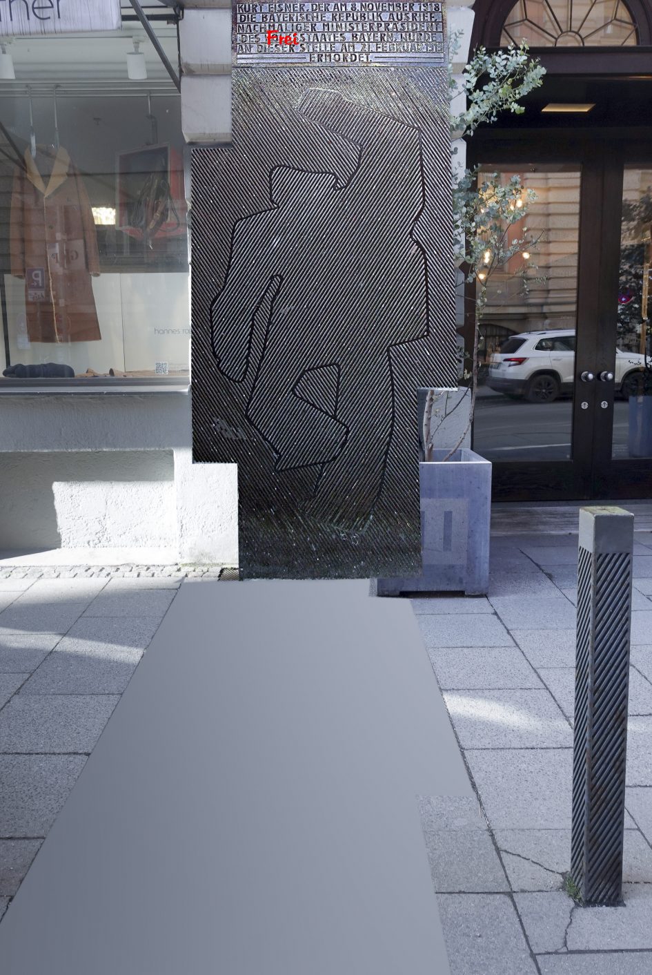 Eisner-Gedenken_Bodenplatte aufgestellt, sie liegt auf der grau belegten Fläche am Boden: Umrisse des von einem "adeligen" Erschossenen Kurt Eisner